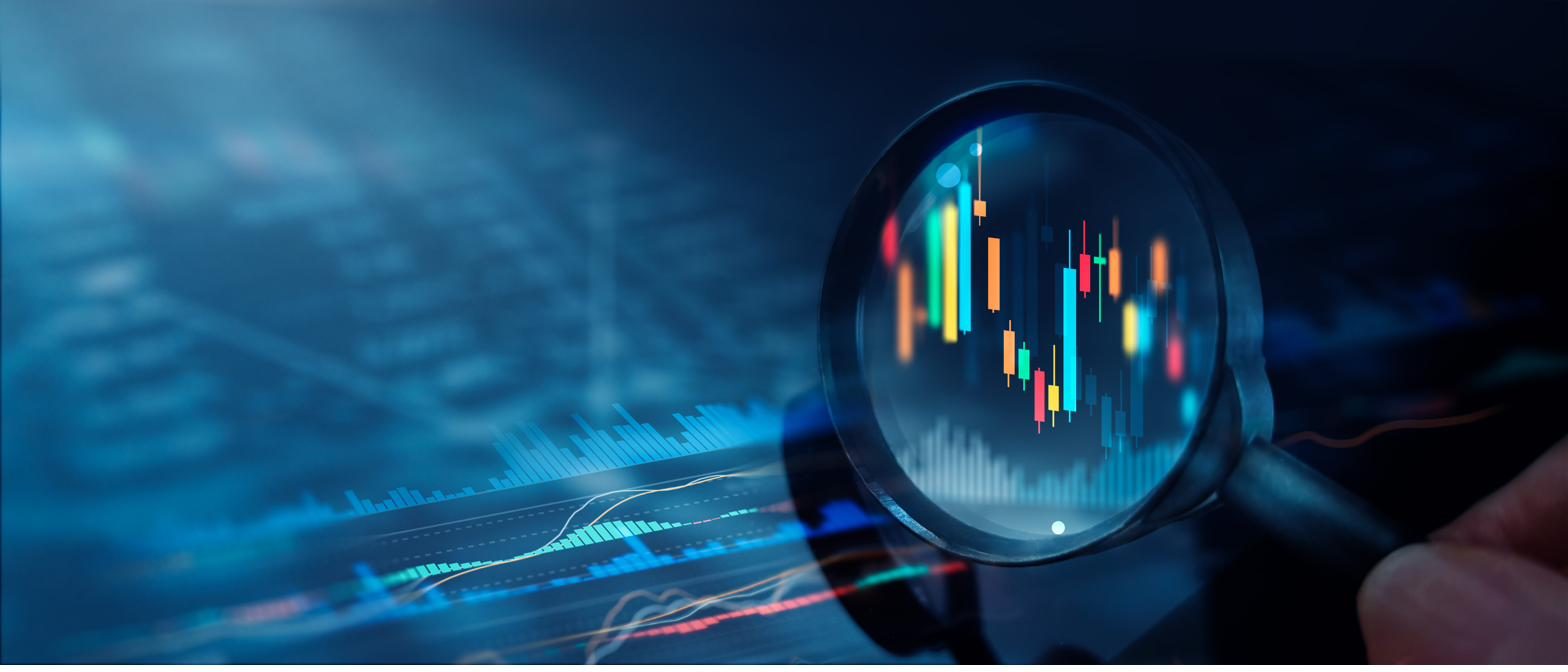 A magnifying glass examining detailed financial and operational data charts