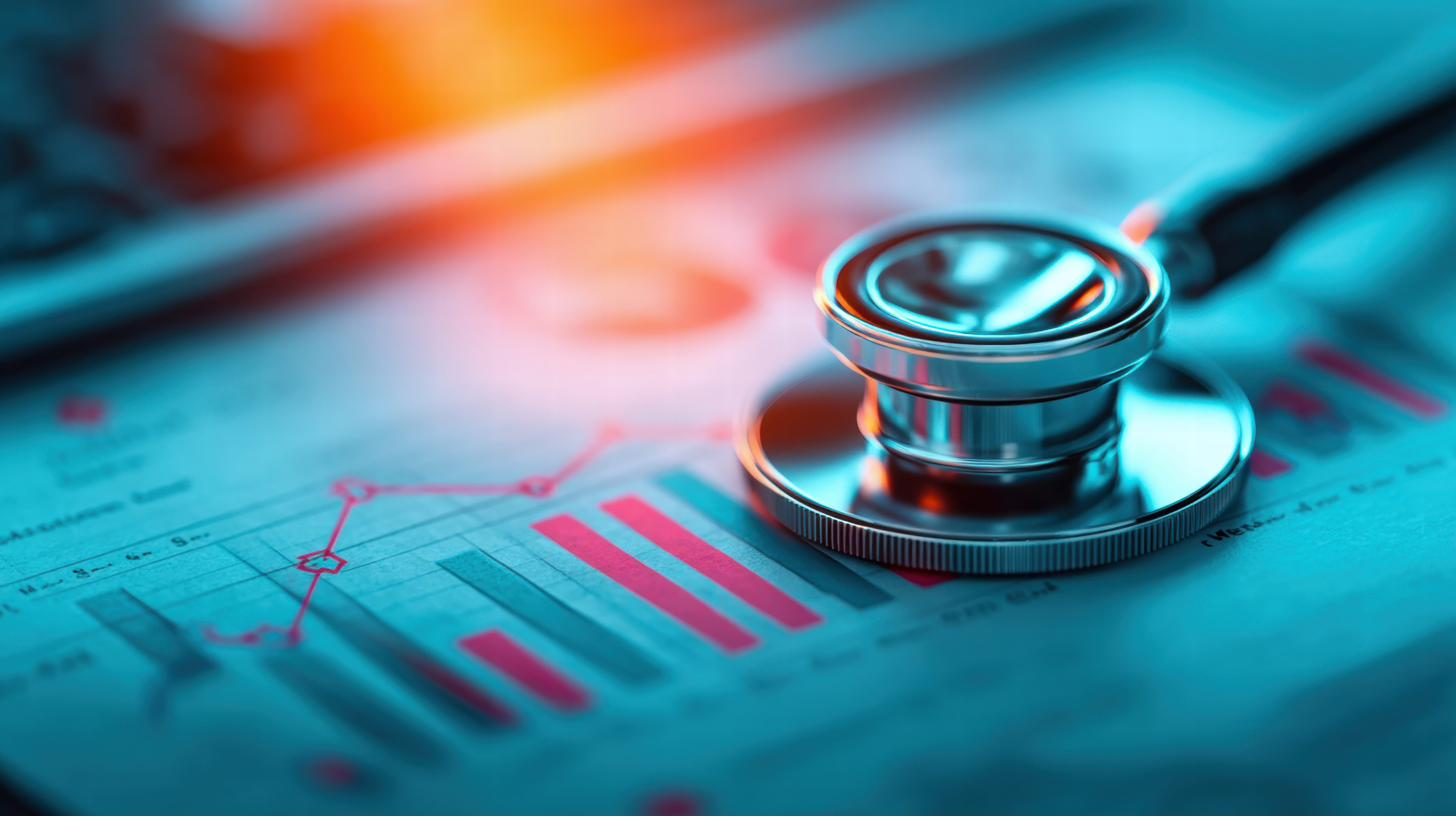A stethoscope resting on printed performance charts and graphs